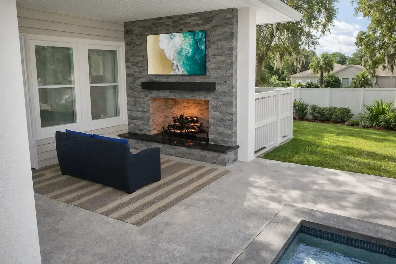 Covered outdoor living space by Serene Spaces Studio