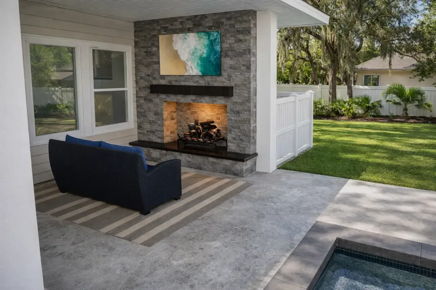 Covered outdoor living space by Serene Spaces Studio
