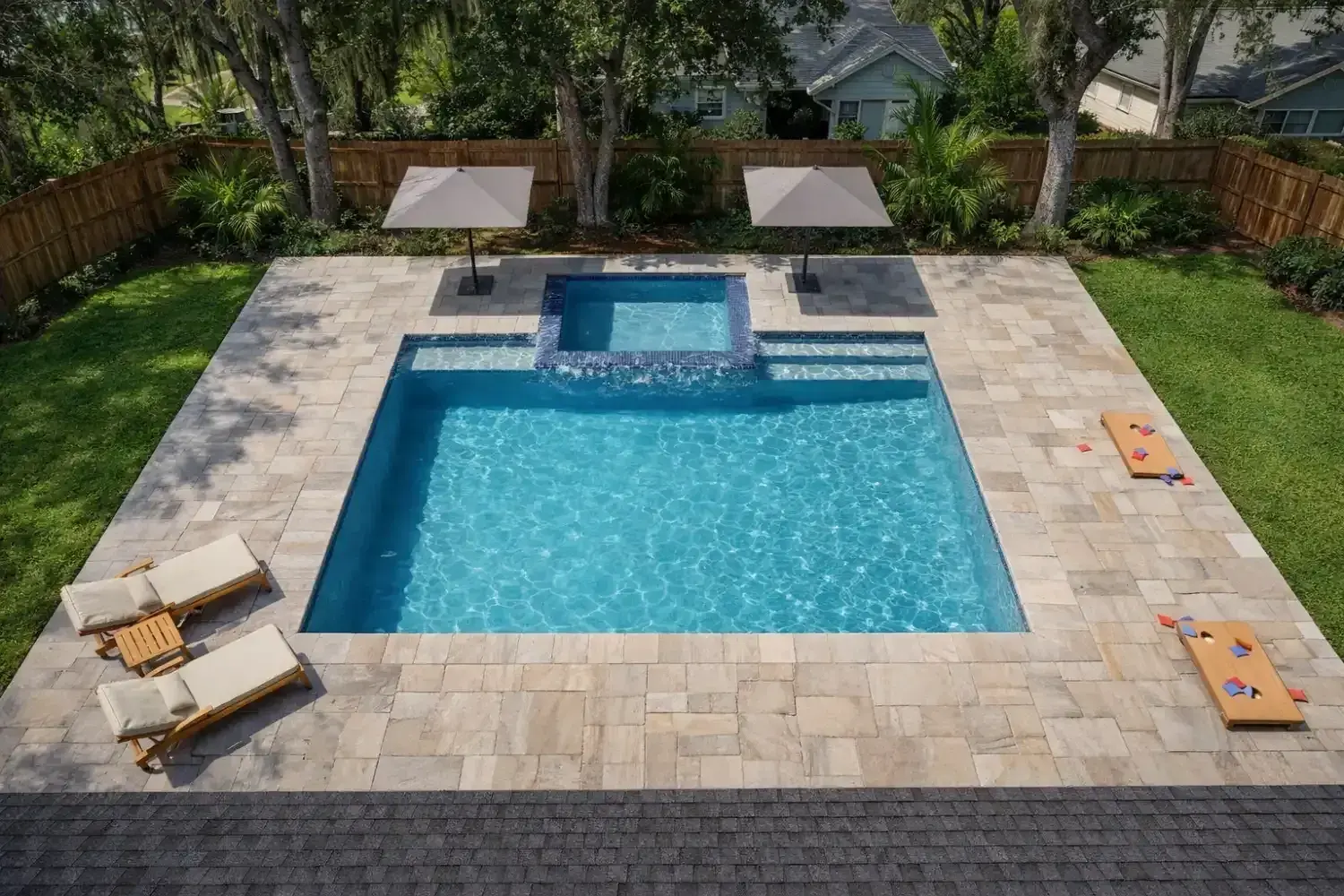 3D rendering: rectangular pool with a raised spa and sun-shelf loungers on a paver deck